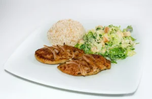 Juicy and perfectly cooked chicken breasts garnished with herbs and lemon slices.